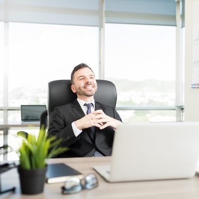 Independent advisor sitting at desk smiling